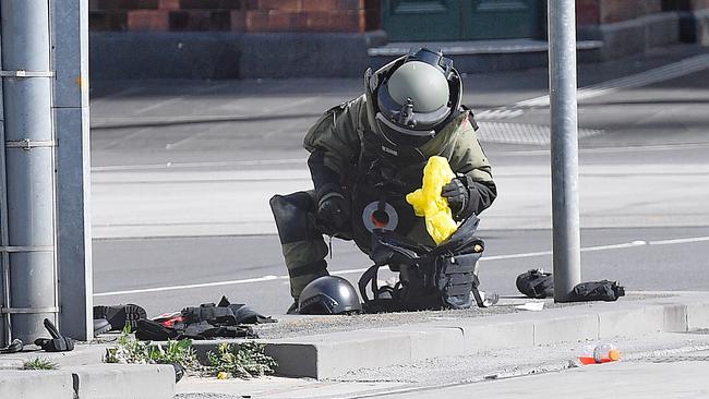 Police and bomb squad inspect the Melbourne CBD site. Picture: Jason Edwards