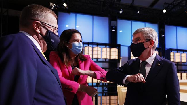 President of the International Olympic Committee Thomas Bach bumps elbows with members of the Brisbane 2032 delegation Australian Olympic Committee president John Coates AC and Queensland Premier Annastacia Palaszczuk. Picture: Toru Hanai/Getty Images