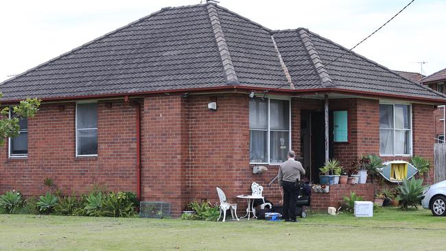 Strike Force Childowla detectives conduct a search warrant at the Pitt Street, Stockton, address where a 22-year-old man was arrested over the death of Graham Cameron. Picture by Peter Lorimer.