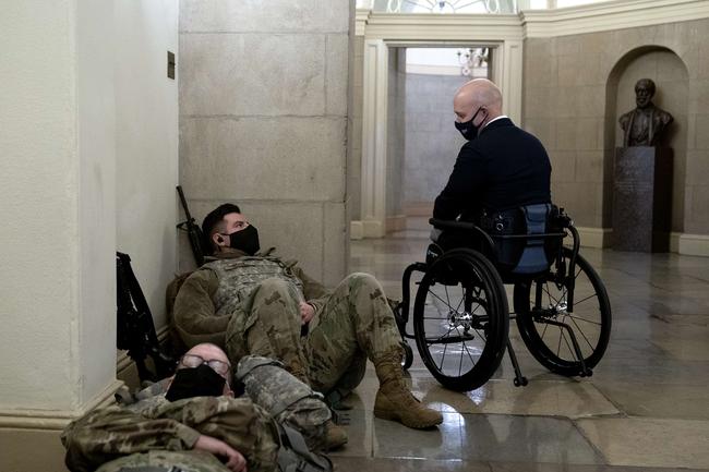 WASHINGTON, DC - JANUARY 13: Rep. Brian Mast (R-FL) (R) greets members of the National Guard in the U.S. Capitol on January 13, 2021 in Washington, DC. Security has been increased throughout Washington following the breach of the U.S. Capitol last Wednesday, and leading up to the Presidential inauguration. Stefani Reynolds/Getty Images/AFP == FOR NEWSPAPERS, INTERNET, TELCOS &amp; TELEVISION USE ONLY ==