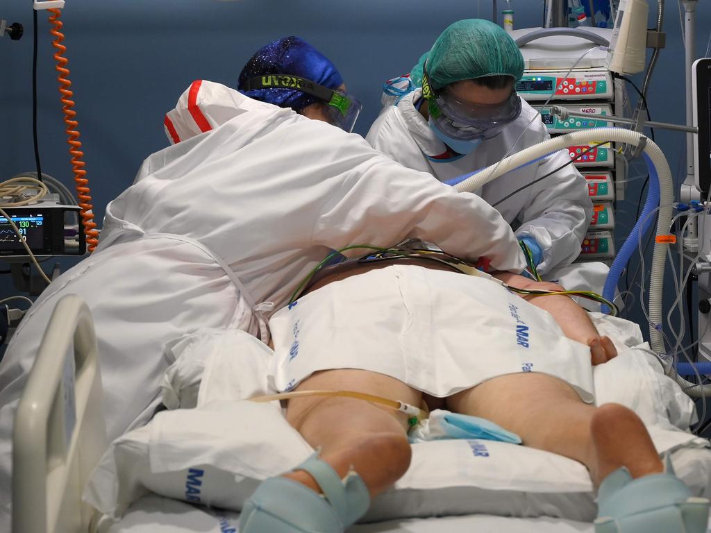 Healthcare workers attend to a patient at the COVID-19 ICU in Hospital Del Mar, Barcelona. Picture: Lluis Gene/AFP