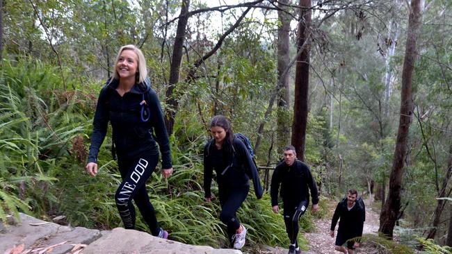 Oxfam trailwalkers Kara Demmrich, Claire Darvodelsky, Mark Darvodelsky and Pat Jackson walking through Hornsby bushland.