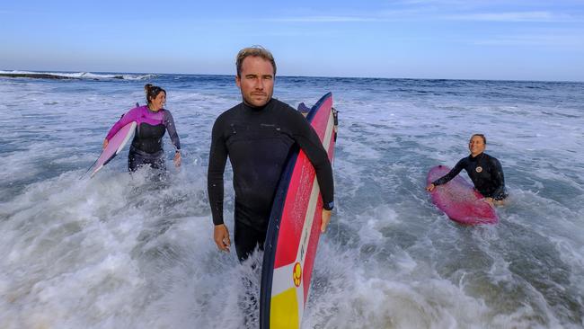 Corangamite independent candidate Damien Cole with fellow activists Katie Griffin and Jessica Hickmott at Bells Beach yesterday. Picture: Luis Enrique Ascui