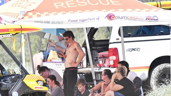 Family and friends wait near the entrance of Stumers Creek on Sunday while a search for a missing Brisbane man continued. Picture: Patrick Woods.