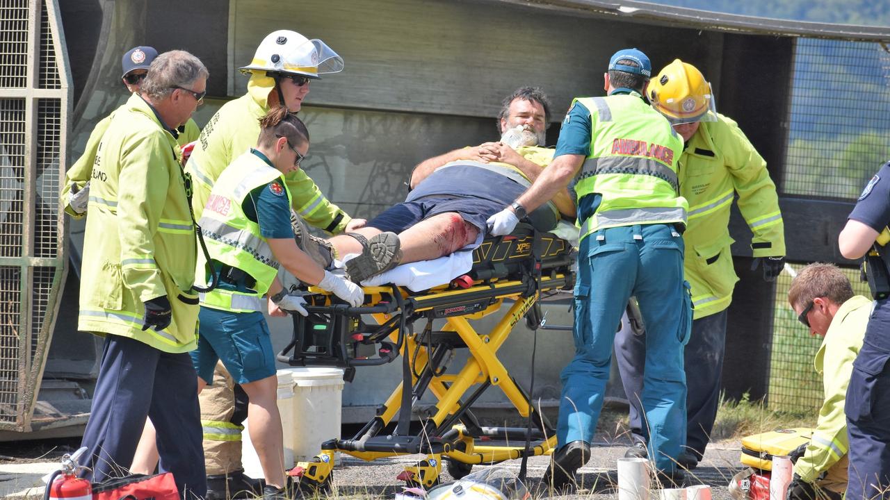 Queensland Ambulance Service paramedics and emergency services colleagues successfully extracting a sugar-cane haul-out driver from his rolled tractor in an accident west of Ingham in 2021. Picture: Cameron Bates