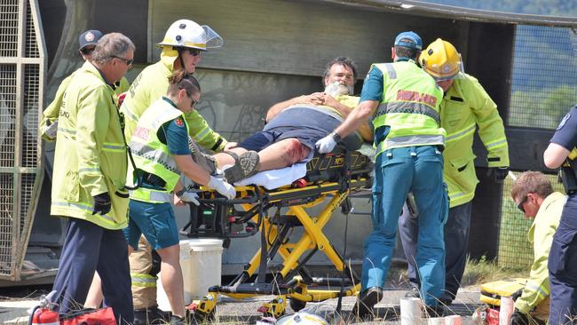Queensland Ambulance Service paramedics and emergency services colleagues successfully extracting a sugar-cane haul-out driver from his rolled tractor in an accident west of Ingham in 2021. Picture: Cameron Bates