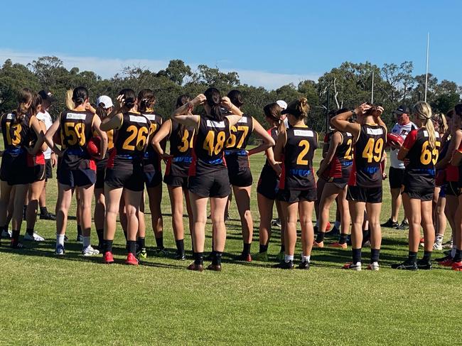 The girls tune in at training.