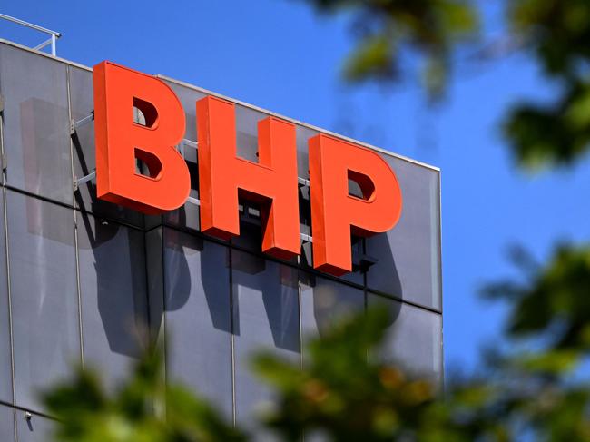 The company logo adorns the side of the BHP gobal headquarters in Melbourne on February 21, 2023. - The Australian multinational, a leading producer of metallurgical coal, iron ore, nickel, copper and potash, said net profit slumped 32 percent year-on-year to 6.46 billion US dollars in the six months to December 31. (Photo by William WEST / AFP)