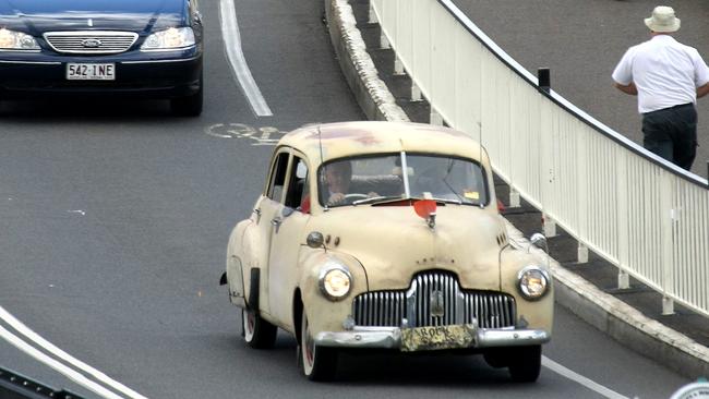 The funeral of Rock 'n' Roll George Kiprios and the procession of his FX Holden car through the city.