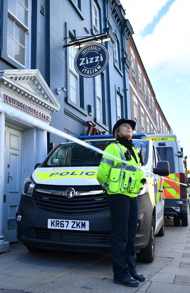 A police officer stands guard outside a cordoned-off branch of the Italian chain restaurant Zizzi. Picture: AFP