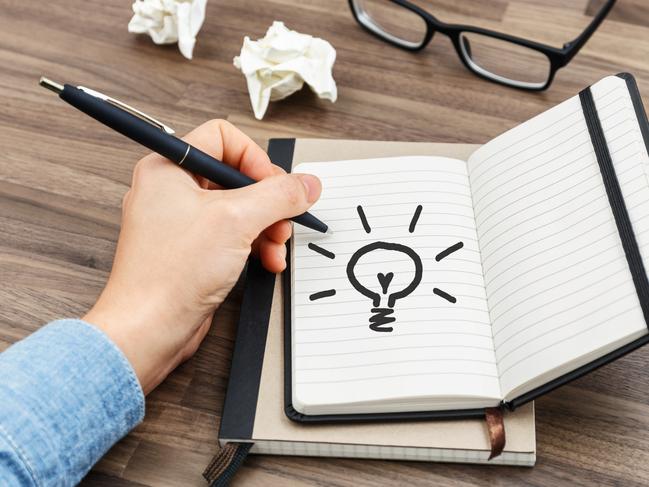 Woman hand writing on notebook on wood desk idea concept