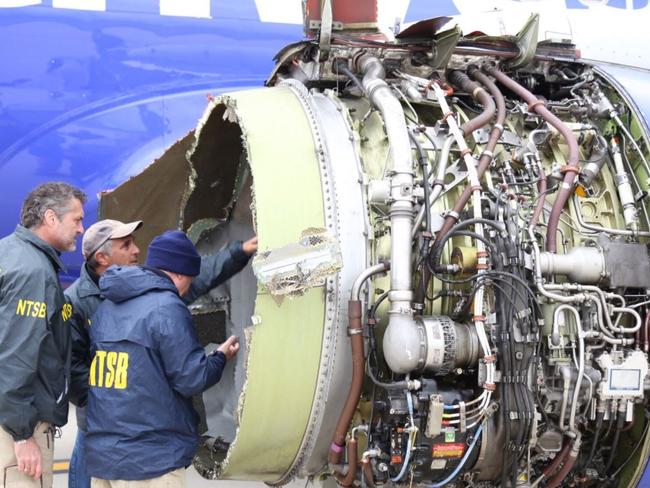 NTSB inspectors examine the engine damage. Picture: Twitter