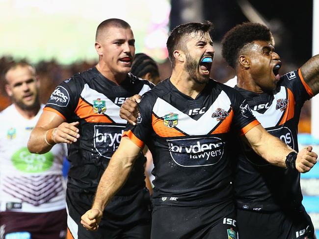 SYDNEY, AUSTRALIA - MARCH 14: James Tedesco of the Tigers celebrates his third try with team mates during the round two NRL match between the Wests Tigers and the Manly Sea Eagles at Leichhardt Oval on March 14, 2016 in Sydney, Australia. (Photo by Mark Nolan/Getty Images)