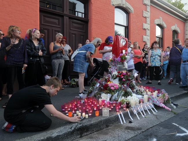 People lay flowers and light candles at the site of the crash. Picture: LUKE BOWDEN