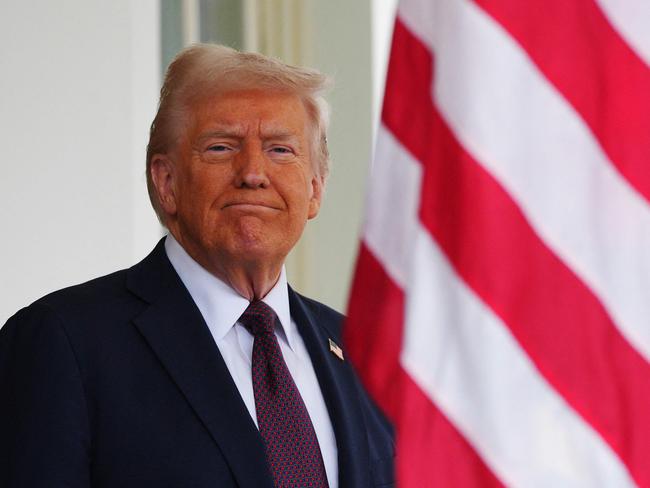 TOPSHOT - US President Donald Trump waits to greet British Prime Minister Keir Starmer at the entrance of the West Wing of the White House in Washington, DC, on February 27, 2025. Starmer is meeting Trump to plead for a US backstop to any Ukraine ceasefire, insisting it would be the only way to stop Russia's Vladimir Putin from invading again. Starmer arrived in Washington late Wednesday to build on a visit by French President Emmanuel Macron, amid growing concerns in Europe that the US leader is about to sell Kyiv short in negotiations with Putin. (Photo by Carl Court / POOL / AFP)