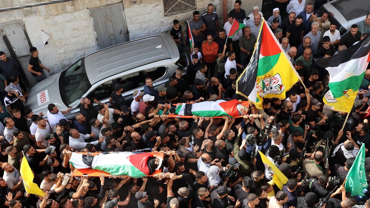 Mourners carry the bodies two Palestinian men, 29-year-old Jihad Saleh, and 17-year-old Mohammed Abu Zer, killed during an Israeli raid on the village of Zawata, west of the city of Nablus, in the Israeli occupied West Bank on October 23, 2023. Picture: Zain JAAFAR / AFP
