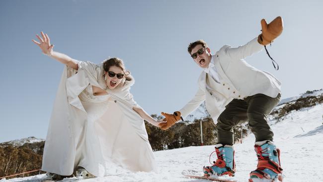 Greg Poole and Georgia Craig went for a snowboard in their wedding clothes pre-wedding. Pictures: Jason Valler