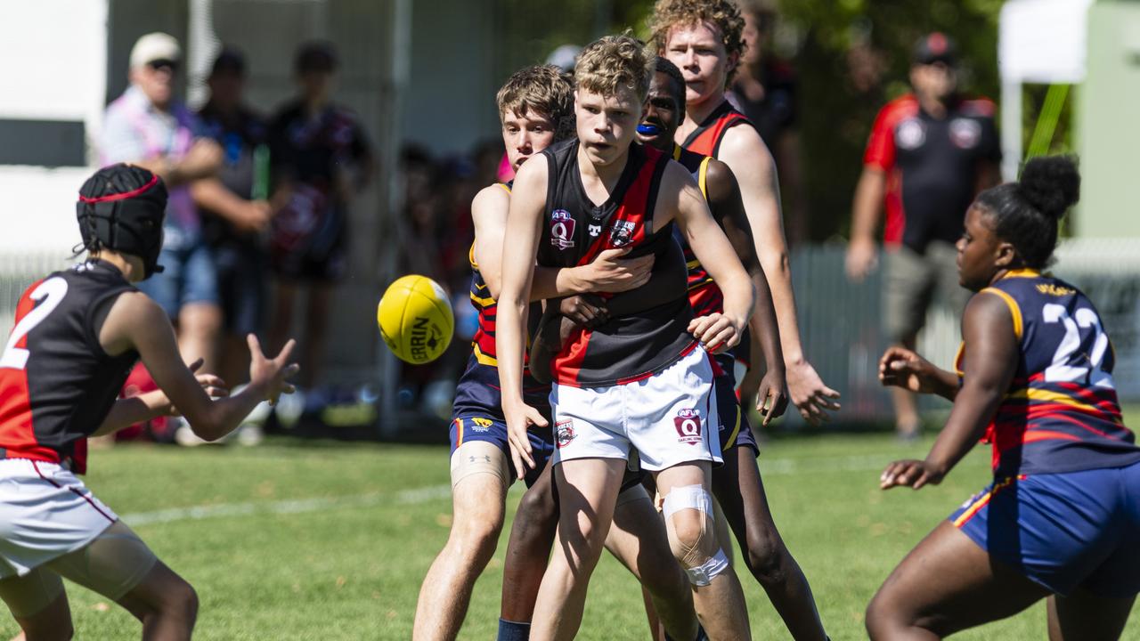 Edward Barwick gets the ball away for South Toowoomba Bombers against University Cougars. Picture: Kevin Farmer