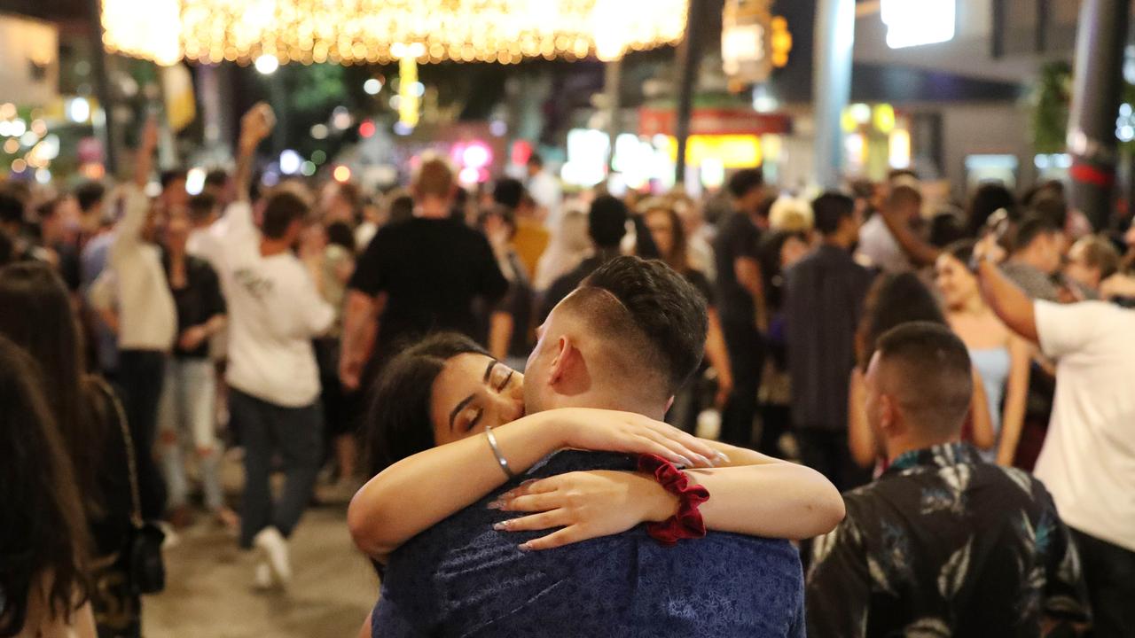 People kissing in the street in Brisbane’s Fortitude Valley as they bring in the start of 2021. Picture: Liam Kidston.