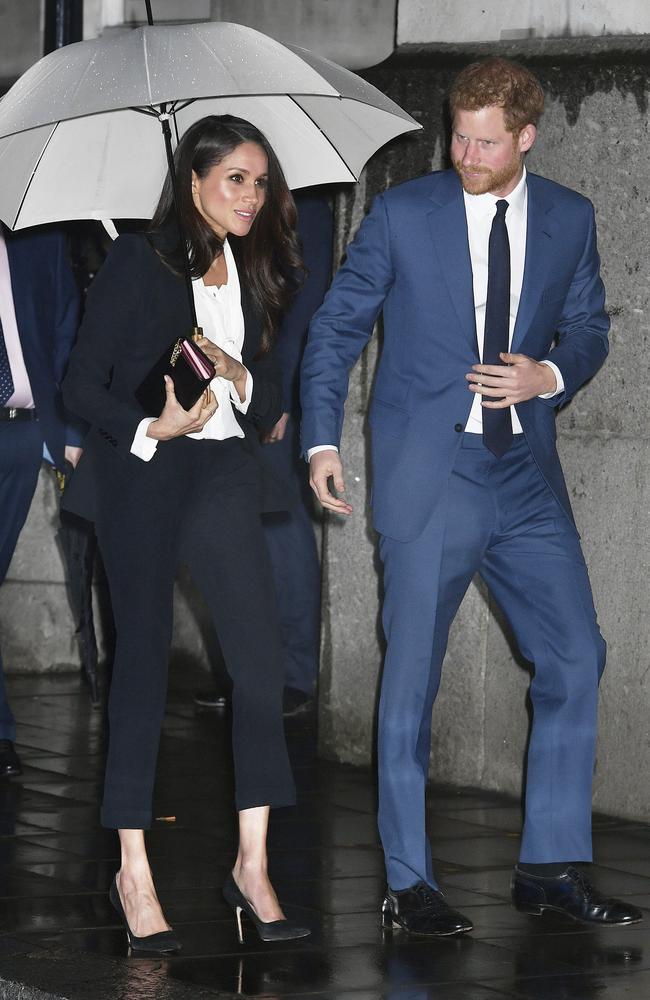A rainy night! Meghan Markle and Prince Harry. Picture: AP
