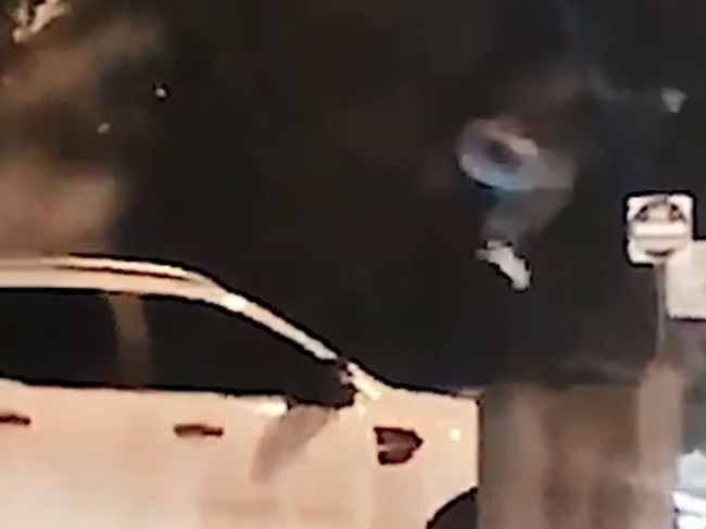 The footage shows the man forcefully jump onto the car.