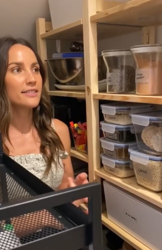 Rachel with her new and improved pantry including glass containers which she says helps her locate things easily. Picture: Instagram/RachaelFinch