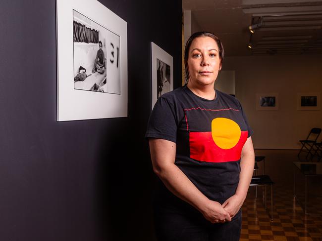 Nala Mansell with the work of aboriginal photographer Ricky Maynard which is showing at the Bett Gallery in Hobart, 30 years since it was produced in response to the Royal Commission into aboriginal deaths in custody.Picture: Linda Higginson