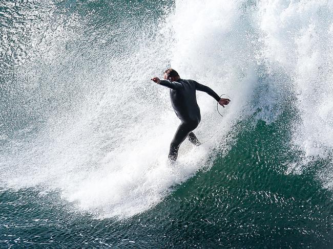 SYDNEY, AUSTRALIA - NewsWire Photos MAY 29, 2021:  A surfer is seen catching a wave in the big surf off Coogee Beach, in Sydney, Australia. Picture: NCA NewsWire / Gaye Gerard