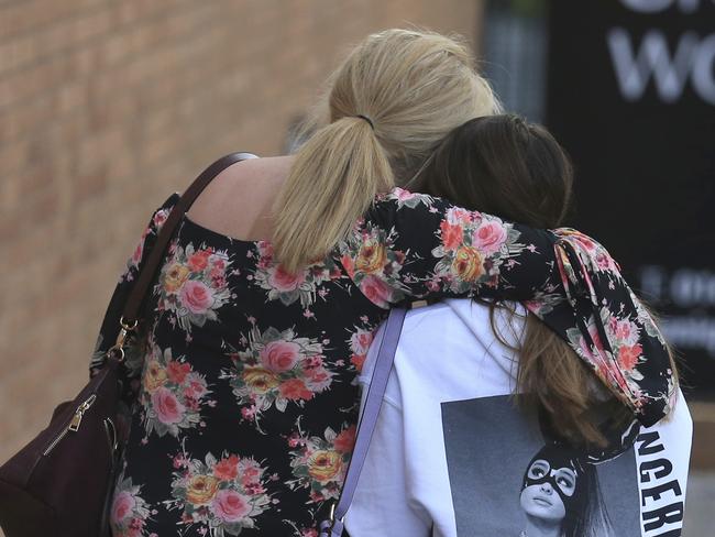 A fan is comforted as she leaves the Park Inn hotel in central Manchester after the attack. Picture: AP