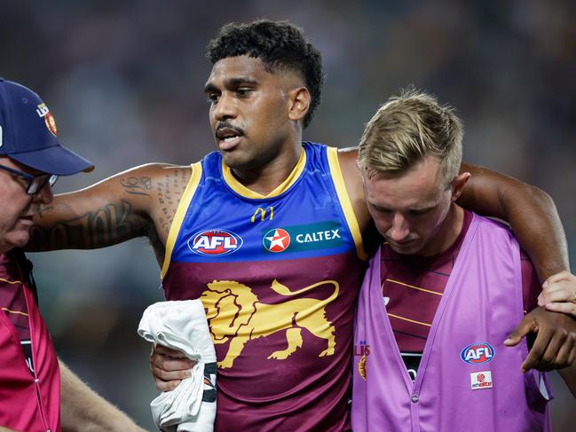 Lions star Keidean Coleman is helped off the field after injuring his knee in March last year. Picture: Russell Freeman/AFL Photos via Getty Images