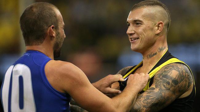 Dustin Martin of the Tigers clashes with Ben Cunnington of the Kangaroos.