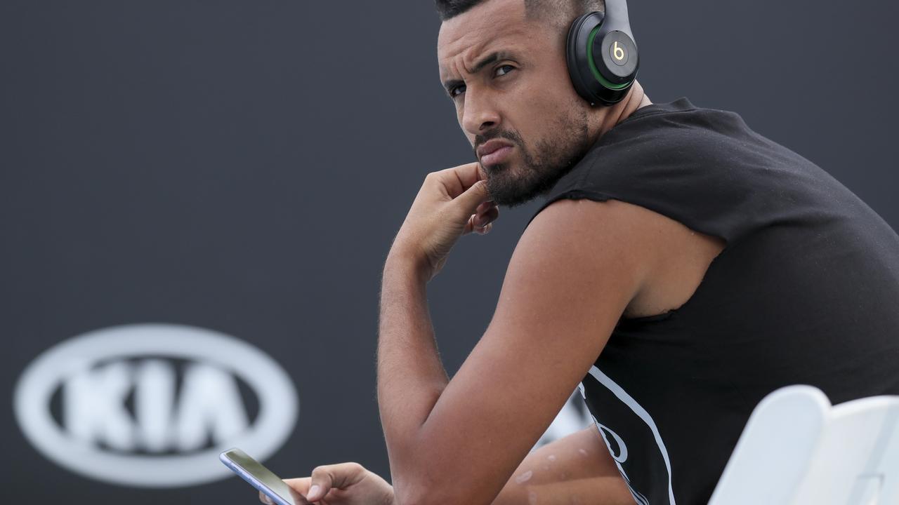 Nick Kyrgios pointed to scratches on his right arm in this picture. Photo by Wayne Taylor/Getty Images