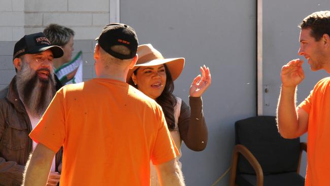 NT Senator Jacinta Price and husband Colin Lillie bat away the flies at the Braitling Primary School, Alice Springs, voting centre ahead of casting their vote in the 2025 federal election, May 3, 2025. Picture: Gera Kazakov