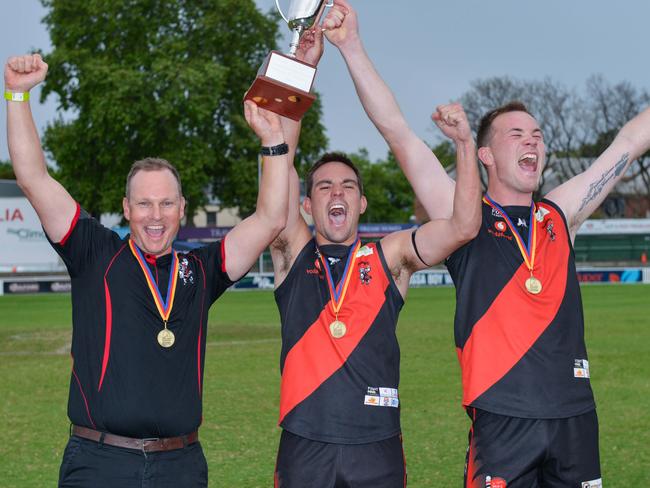 Adelaide Footy League division two grand final - Tea Tree Gully v Sacred Heart Old Collegians at Norwood Oval, October 3, 2020. Coach Justin Maschotta, co-captains Chad Schoenmakers and Blake Penney hood up the trophy. Picture: Brenton Edwards