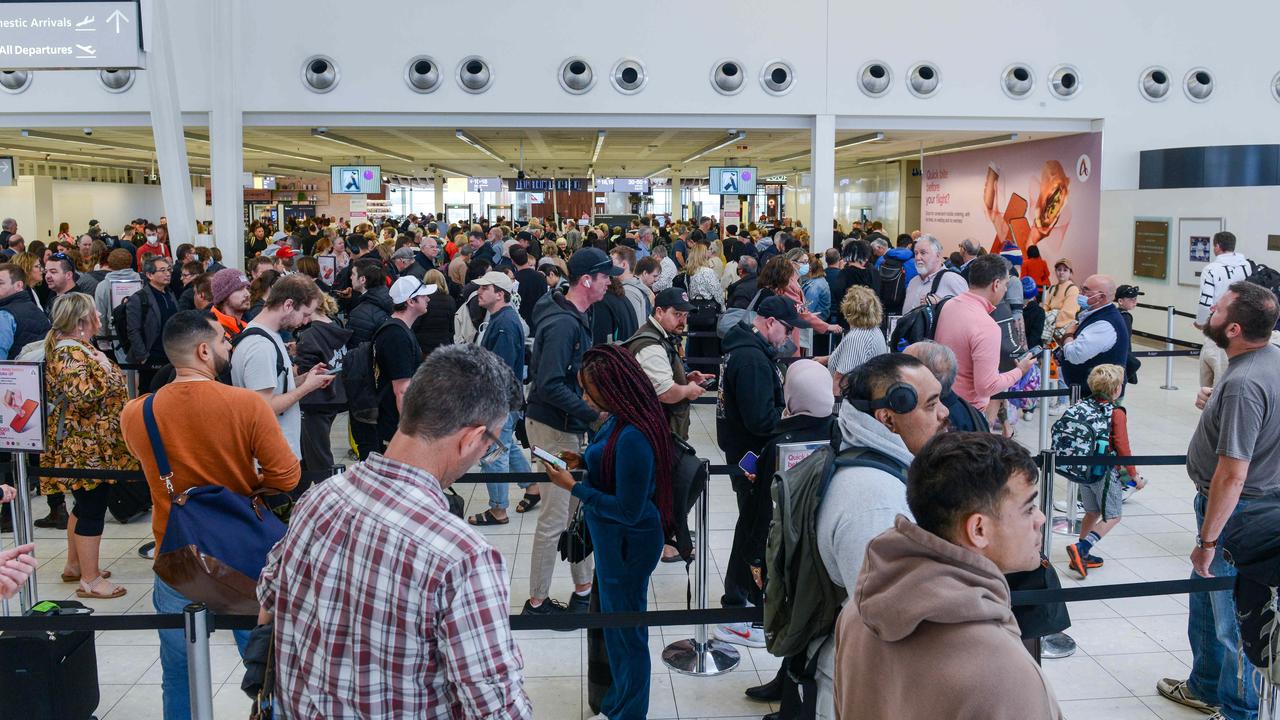 Passengers queue to be screened at Adelaide Airport after being evacuated due to a security breach. Picture: Brenton Edwards