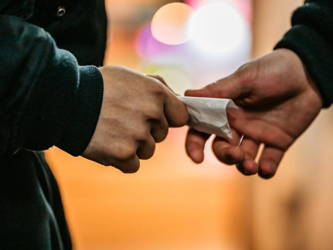 Addict young man have meeting with dealer at night to buy dose of white powder cocaine.