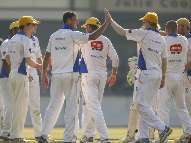 The East Sandringham players gather after a wicket.