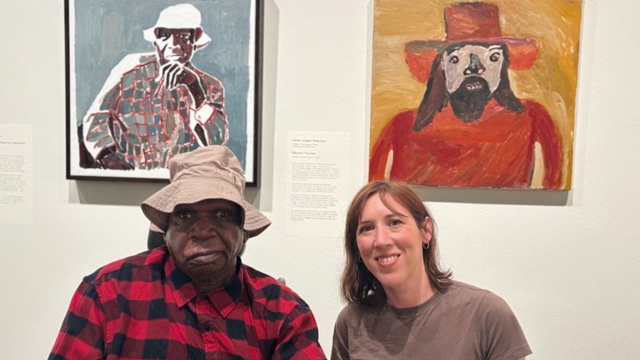 Mr Robertson with Clara Adolphs, who painted the portrait (left) of Mr Robertson. Picture: Supplied