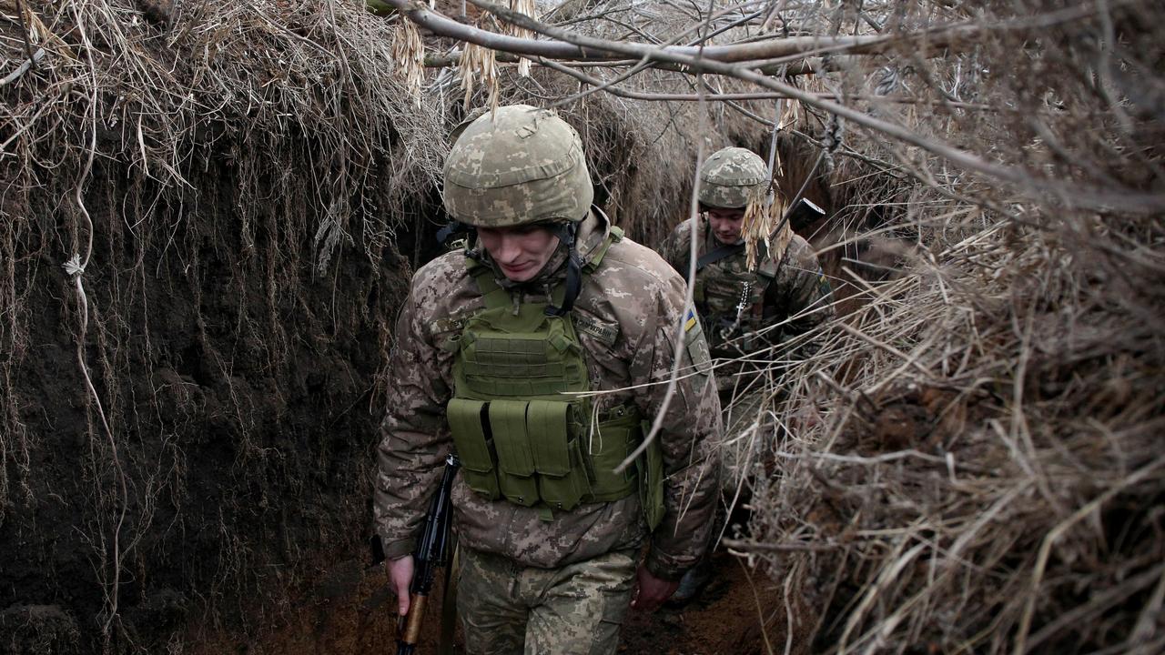 Servicemen of Ukrainian Military Forces walk as they keep position on the front line with Russia backed separatists, near Novolugansk. Picture: Anatolii Stepanov/AFP