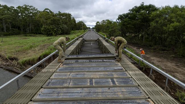 Australian Army soldiers from the 3rd Combat Engineer Regiment assemble a Medium Girder Bridge at Ollera Creek, Townsville, Queensland, during Defence Assistance to the Civil Community (DACC) following severe weather and flooding across the region. PHOTO: CPL Riley Blennerhassett