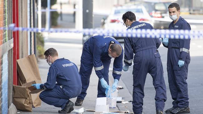 Forensic police examine items at the scene of the shooting outside Love Machine nightclub in Prahran in 2019.