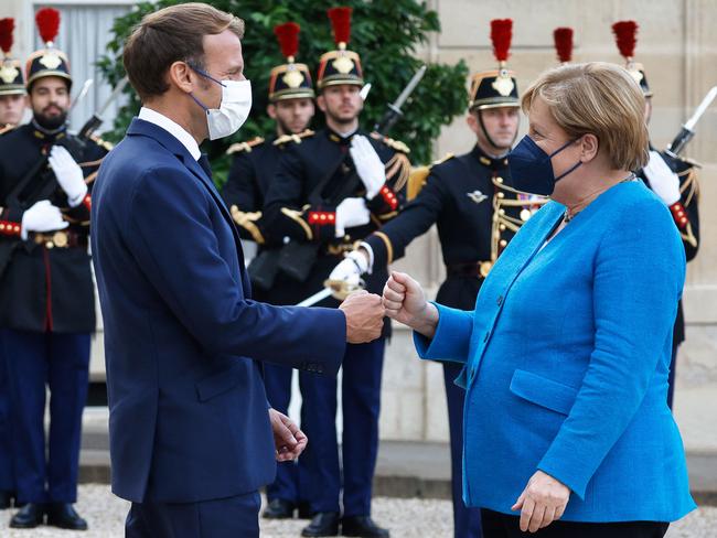 French President Emmanuel Macron (L) greets German Chancellor Angela Merkel. After Merkel steps down there won’t be a German team ready for action. Picture: AFP