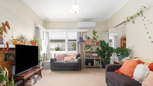 Classic lighting, cornies and brick mantel feature in the living room.