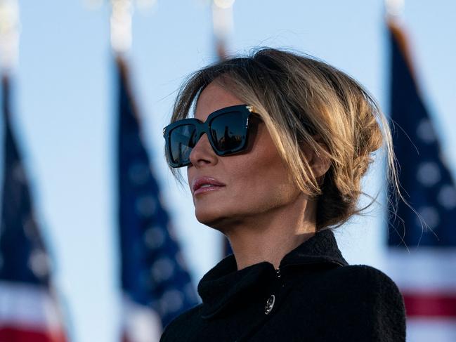 (FILES) Outgoing First Lady Melania Trump listens as her husband outgoing US President Donald Trump addresses guests at Joint Base Andrews in Maryland on January 20, 2021. Extremely discreet in the White House and even more reserved since leaving Washington, Melania Trump is keeping observers guessing whether she will appear, however warily, on the campaign trail alongside her husband. Aloof and enigmatic, the Slovenian-born former model has been noticeably absent as husband Donald Trump makes his third bid for the White House. (Photo by ALEX EDELMAN / AFP)