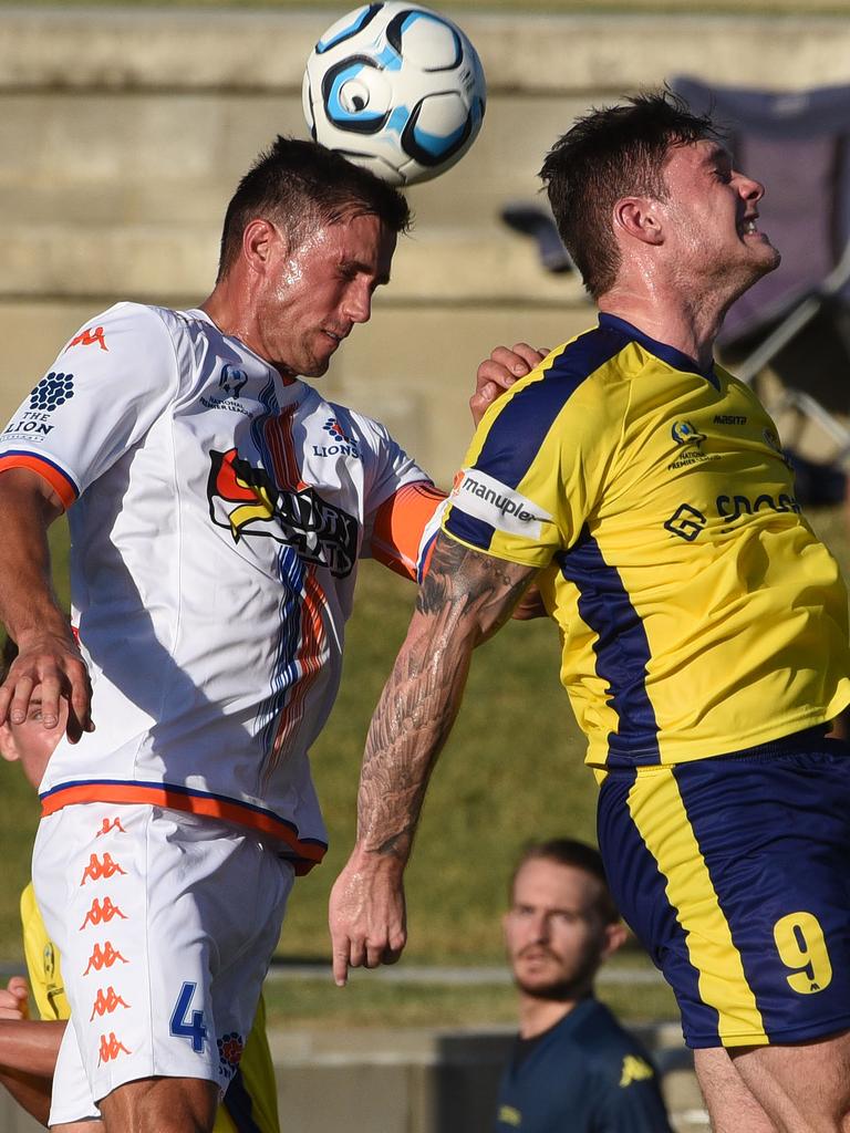 Matija Simic makes a header despite the best efforts of Brandon Reeves. Picture: Steve Holland