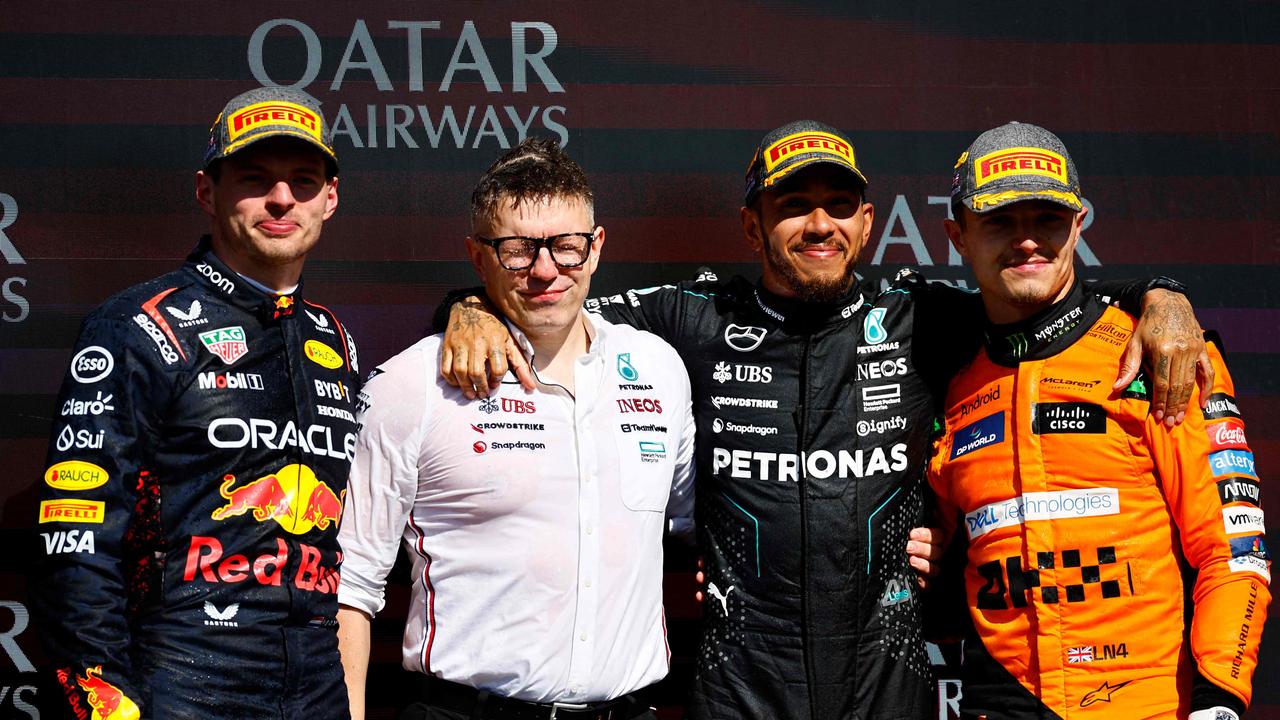 Verstappen, Hamilton and Norris on the podium with Hamilton’s race engineer Peter Bonnington. (Photo by BENJAMIN CREMEL / AFP)