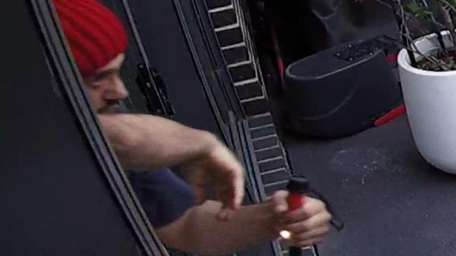 Police would like to speak with this red beanie-wearing man has been caught on camera fleeing a house in Hadfield.