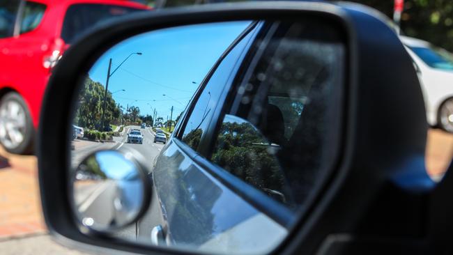 A shot on the side mirror showing a police car behind.