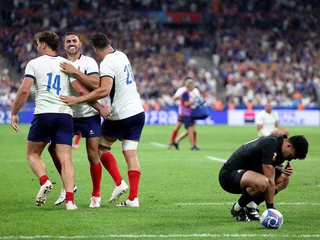 PARIS, FRANCE - SEPTEMBER 08: Melvyn Jaminet, Damian Penaud and Paul Boudehent of France celebrate their side's second try as Richie Mo'unga of New Zealand looks dejected during the Rugby World Cup France 2023 Pool A match between France and New Zealand at Stade de France on September 08, 2023 in Paris, France. (Photo by Warren Little/Getty Images)