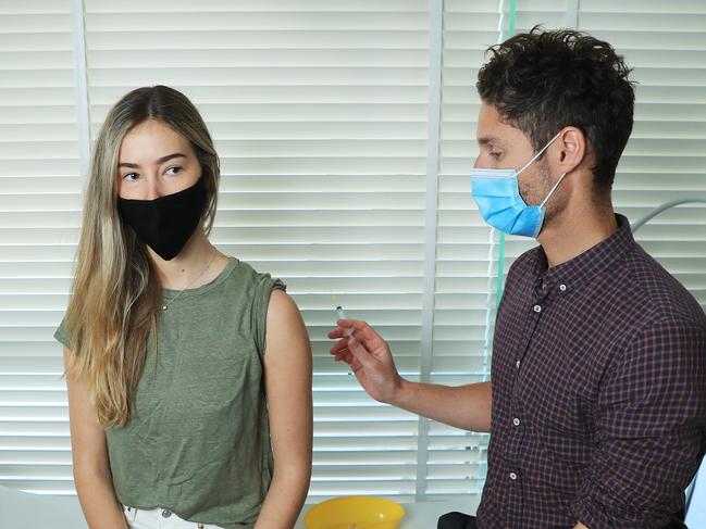 29/6/21: Gabi Blomson receiving the AstraZeneca jab from Dr Stephen Massey at Bondi Doctors, following the announcement under 40s are able to get the shot from the GP immediately. John Feder/The Australian.